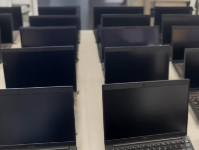 A computer lab filled with several laptops.